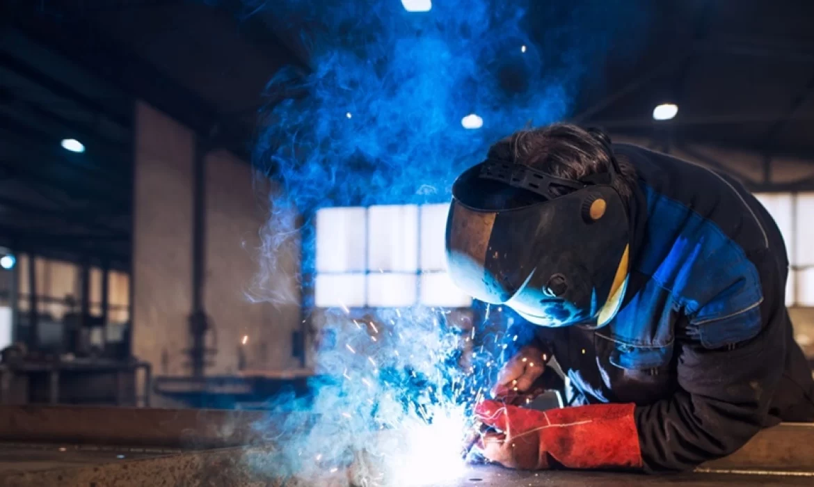 close-up-view-worker-welding-metal-construction-industrial-workshop